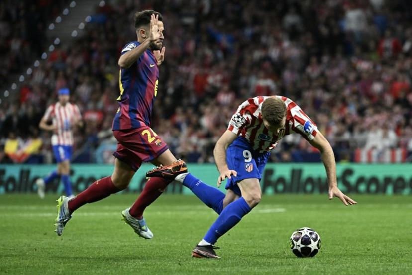 Atletico Madrid's Norwegian forward #09 Alexander Sorloth (R) falls to the ground after colliding with Barcelona's Spanish defender #24 Eric Garcia during the UEFA Champions League quarter final second leg football match between Club Atletico de Madrid and FC Barcelona at Metropolitano Stadium in Madrid on April 14, 2026. Javier SORIANO / AFP