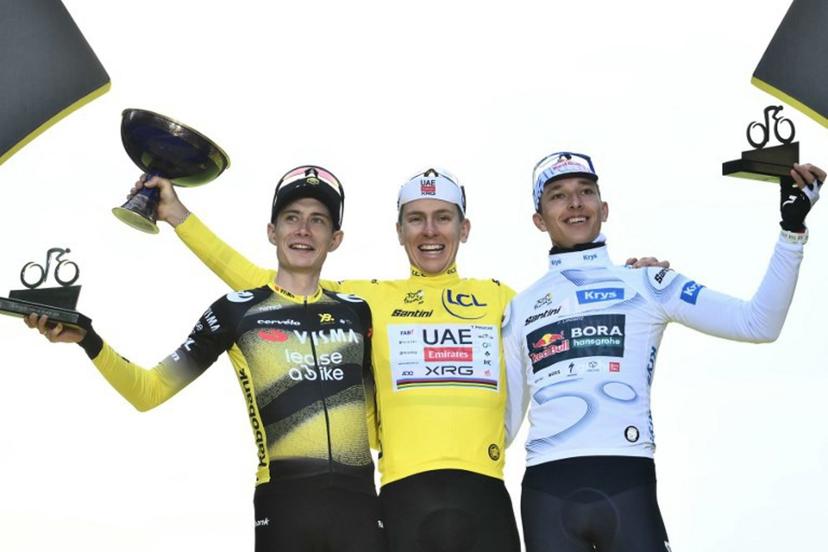 Overall winner UAE Team Emirates - XRG team's Slovenian rider Tadej Pogacar (C) wearing the overall leader's yellow jersey, second-placed Team Visma - Lease a bike team's Danish rider Jonas Vingegaard (L), and third-placed Red Bull - BORA - hansgrohe team's German rider Florian Lipowitz (R) celebrate on the podium after the 21st and final stage of the 112th edition of the Tour de France cycling race, 132.3 km between Mantes-la-Ville and Paris Champs-Élysees, on July 27, 2025. Marco BERTORELLO / AFP