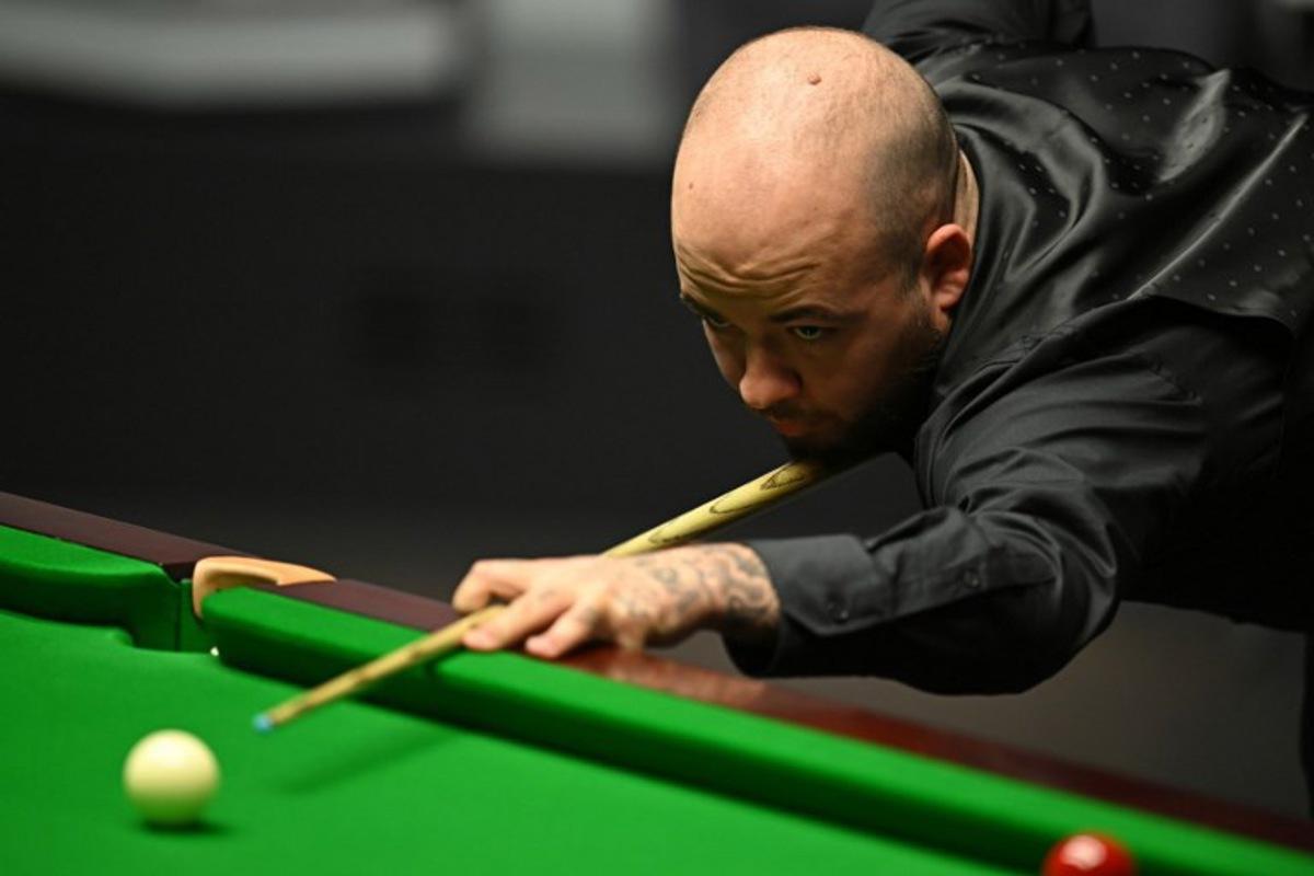 Belgium's Luca Brecel plays a shot against England's Mark Selby during the afternoon session on day two of their World Championship Snooker final match at The Crucible in Sheffield, northern England on May 1, 2023. Oli SCARFF / AFP