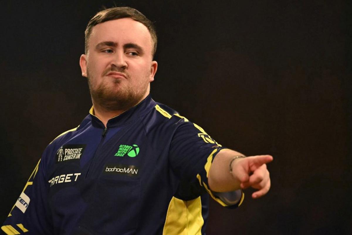 England's Luke Littler reacts while playing against Netherlands' Michael van Gerwen during the PDC World Darts Championship final, at Alexandra Palace in London on January 3, 2025. Ben STANSALL / AFP