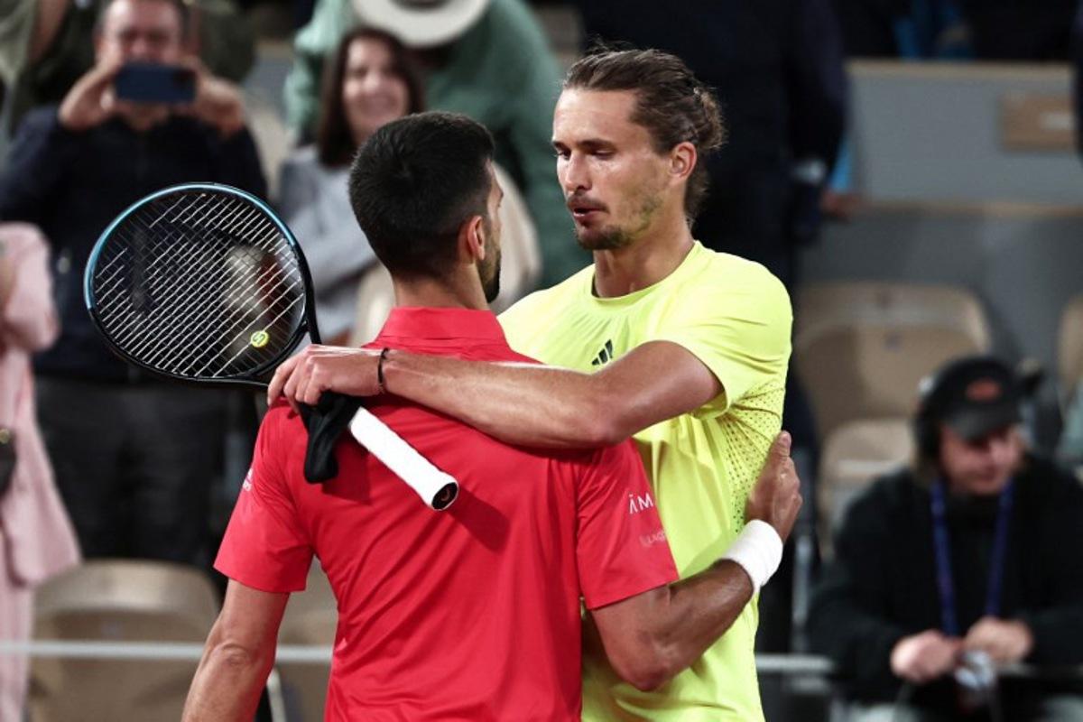 Winner Serbia's Novak Djokovic (L) cheers Germany's Alexander Zverev at the end of their men's singles quarter-final match on day 11 of the French Open tennis tournament on Court Philippe-Chatrier at the Roland-Garros Complex in Paris on June 4, 2025. Thibaud MORITZ / AFP