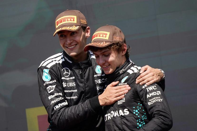 (L/R) Race winner Mercedes' British driver George Russell celebrates with teammate and third place finisher Mercedes' Italian driver Kimi Antonelli on the podium after the 2025 Formula 1 Grand Prix du Canada at Circuit Gilles-Villeneuve in Montreal, Canada, on June 15, 2025. Geoff Robins / AFP