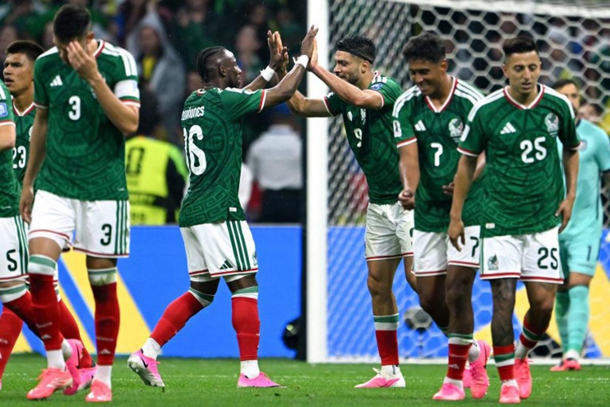 Mexico's forward #09 Raul Jimenez celebrates with teammate forward #16 Julian Quinones scoring his team's second goal during the 2026 World Cup round of 32 football match between Mexico and Ecuador at the Mexico City Stadium in Mexico City on June 30, 2026. CARL DE SOUZA / AFP