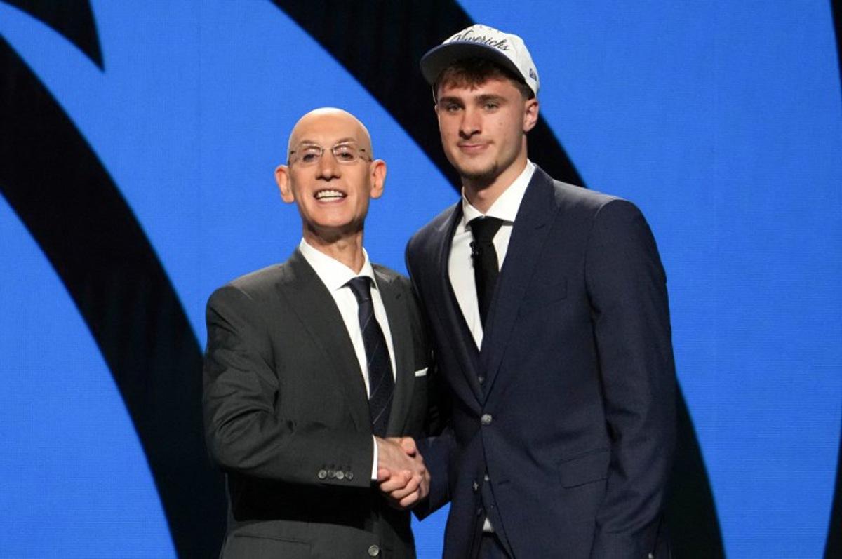 US basketball player Cooper Flagg (R) shakes hands with NBA Commissioner Adam Silver after being selected first overall by the Dallas Mavericks during the opening round of the 2025 NBA Draft at Barclays Center in Brooklyn, New York, on June 25, 2025. Versatile US college teen star Cooper Flagg was selected first overall in the NBA draft on June 25 by the Dallas Mavericks, where he'll join a star-laden team already touted as a playoff threat next season. Flagg, a consensus pick as the top US college player as a freshman at Duke University last season, is the second-youngest player taken first overall. TIMOTHY A. CLARY / AFP