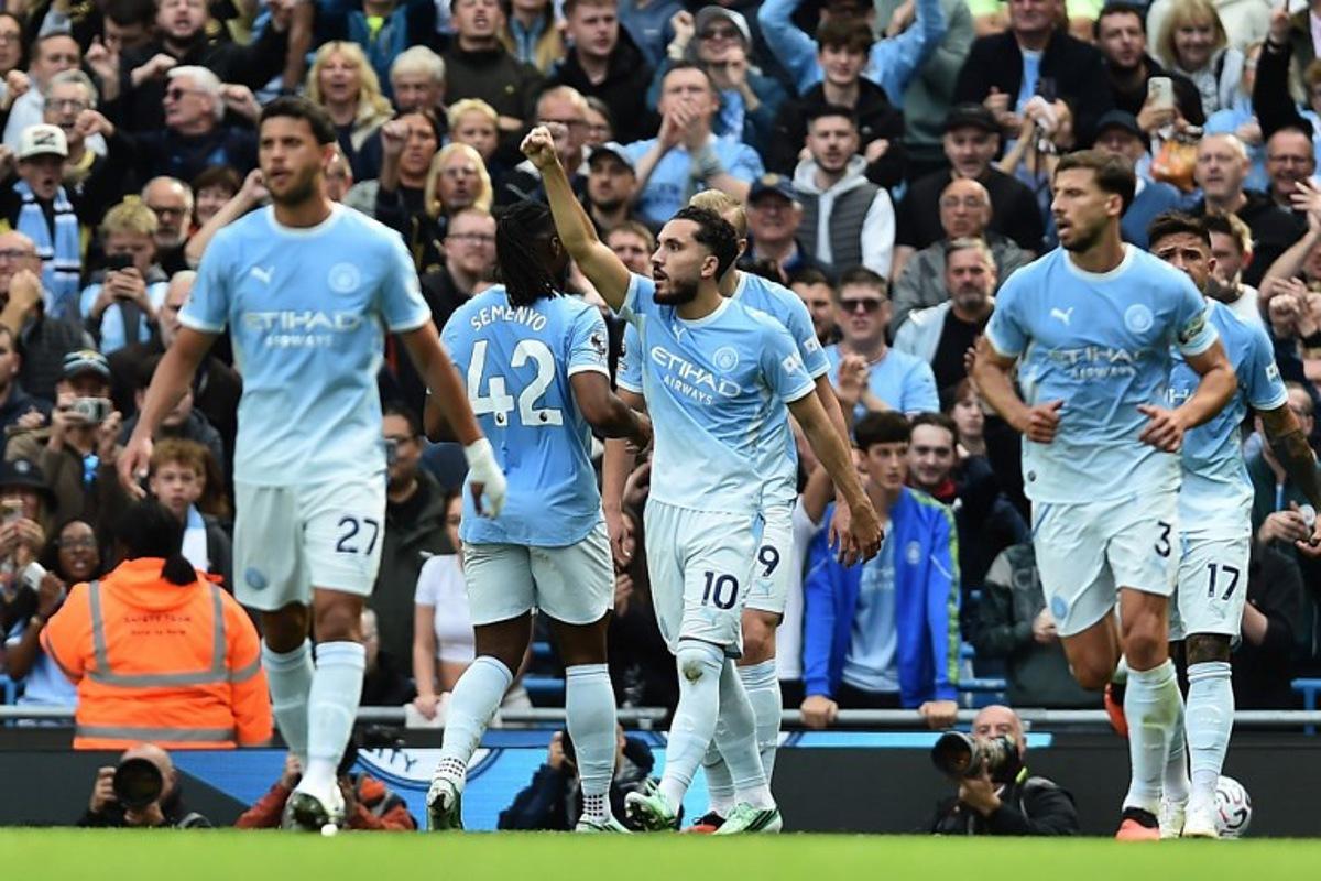 Manchester City's French midfielder #10 Rayan Cherki (C) celebrates with teammates after scoring their second goal during the English Premier League football match between Manchester City and Sunderland at the Etihad Stadium in Manchester, north west England, on September 20, 2026. PETER POWELL / AFP