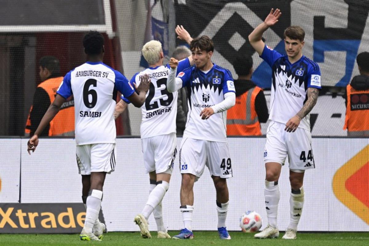 Hamburg's Belgian-Congolese midfielder #06 Albert Sambi Lokonga, Hamburg's Danish midfielder #23 Albert Gronbaek, Hamburg's German forward #49 Otto Stange and Hamburg's Croatian defender #44 Luka Vuskovic celebrate after scoring the opening goal during the German first division Bundesliga football match between Bayer Leverkusen and Hamburger SV (HSV) in Leverkusen, western Germany, on May 16, 2026. INA FASSBENDER / AFP