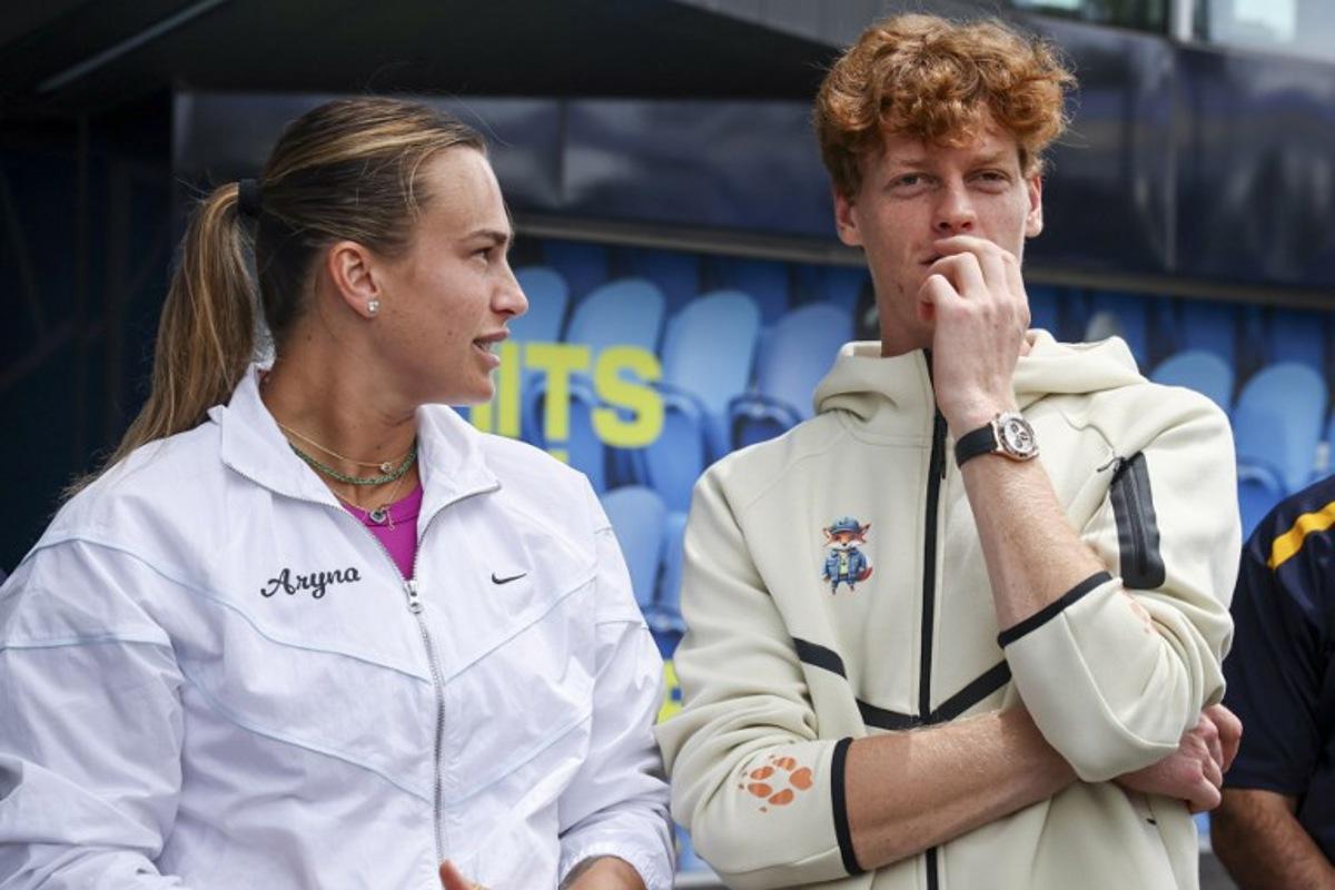 Current Australian Open tennis champions Aryna Sabalenka (L) of Belarus and Italy's Jannik Sinner talk as they wait to participate in an offical ceremony for the main draw, ahead of the Australian Open tennis tournament in Melbourne on January 9, 2025. DAVID GRAY / AFP