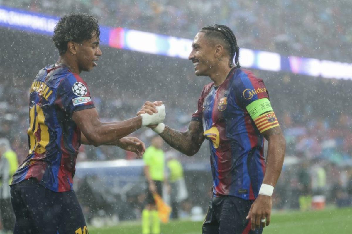 Barcelona's Brazilian forward #11 Raphinha (R) celebrates scoring his team's first goal with teammate Barcelona's Spanish forward #10 Lamine Yamal during the UEFA Champions League first round day 1 football match between FC Barcelona and Feyenoord at Camp Nou stadium in Barcelona on September 9, 2026. Lluis GENE / AFP