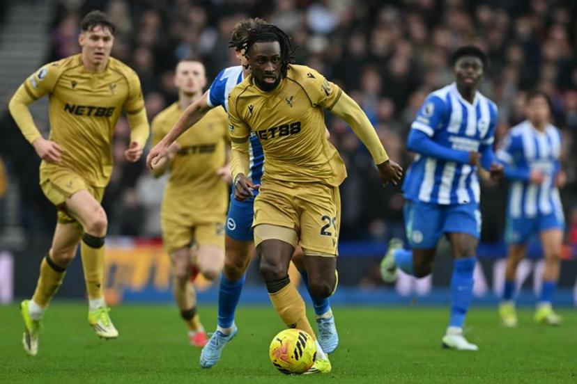 Crystal Palace's Ivorian striker #29 Evann Guessand runs with the ball during the English Premier League football match between Brighton and Hove Albion and Crystal Palace at the American Express Community Stadium in Brighton, southern England on February 8, 2026. Glyn KIRK / AFP