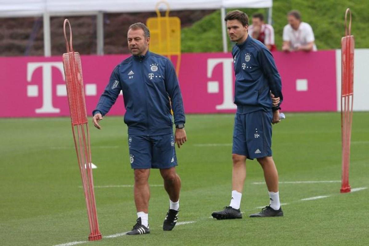 Bayern Munich's German head coach Hansi Flick (L) and and assistant coach analysis Danny Rohl attend a training session during the team's winter camp in Qatar's capital Doha on January 9, 2020. MUSTAFA ABUMUNES / AFP