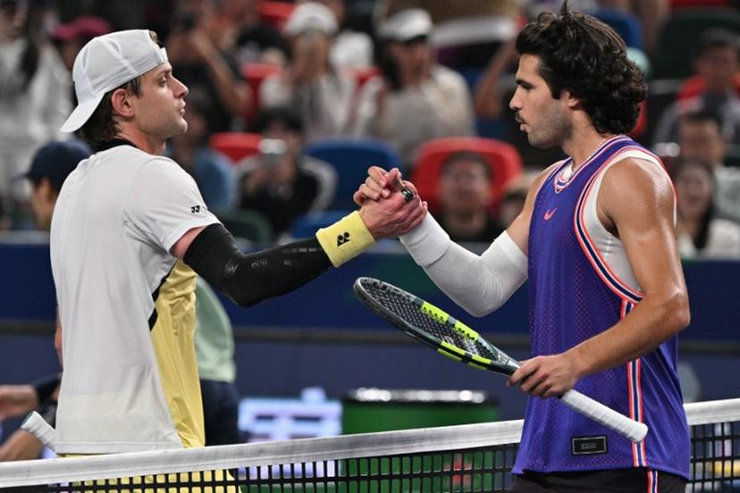 Belgium's Zizou Bergs (L) shakes hands with Spain's Carlos Alcaraz at the end of their men's singles match at the Shanghai Masters tennis tournament in Shanghai on October 12, 2026. Hector RETAMAL / AFP