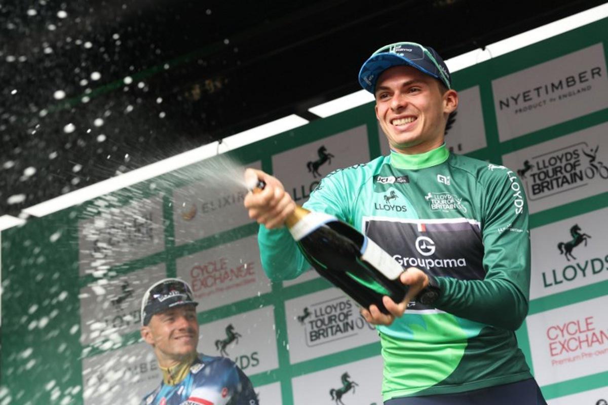 Groupama FGJ's French rider Romain Gregoire sparys the champagne as he celebrate his overall victory in the Tour of Britain cycling race, in Cardiff on September 7, 2025. Darren Staples / AFP