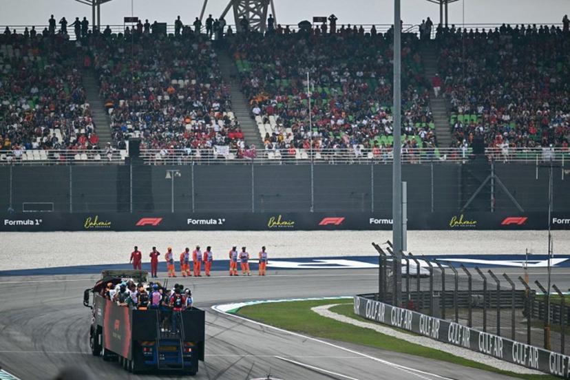 Supporters watch as drivers ride on a truck during the Driver's Parade ahead of the Formula One Bahrain Grand Prix in Sepang on October 4, 2026. Lillian SUWANRUMPHA / AFP