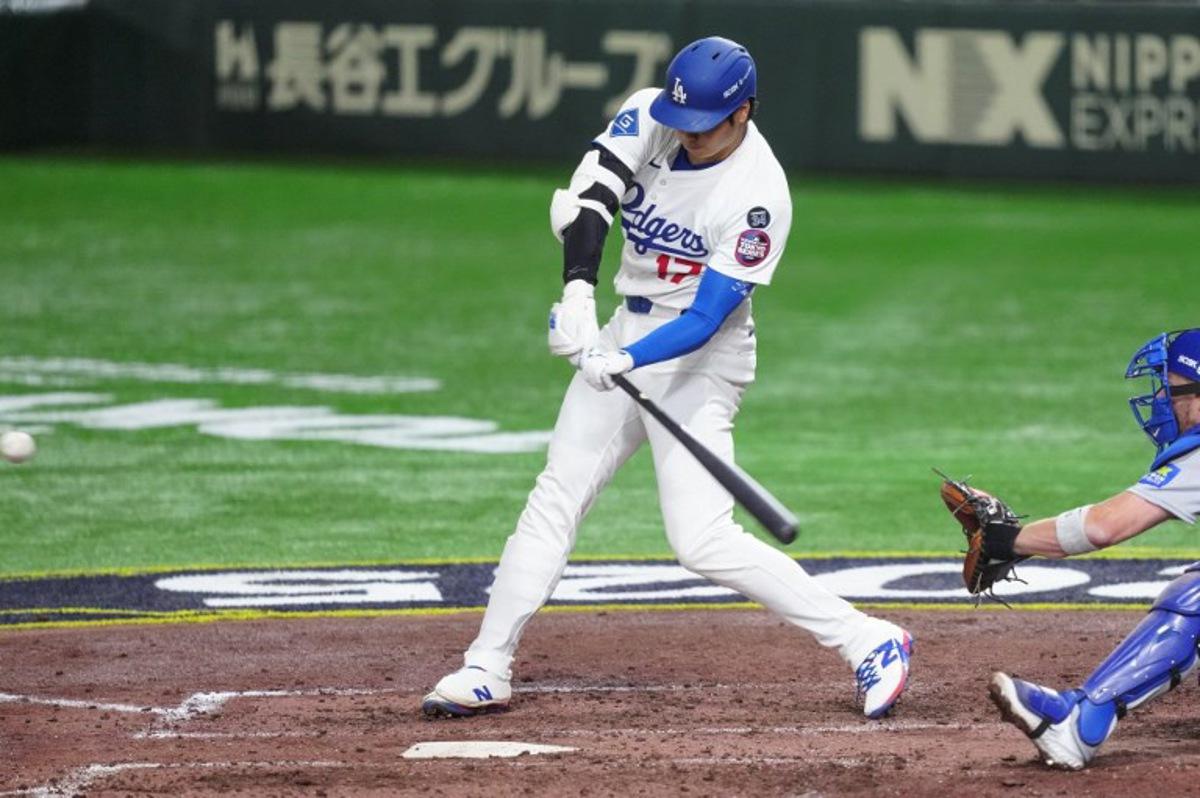Los Angeles Dodgers's Shohei Ohtani hits a home-run in the fifth inning during the baseball game between Los Angeles Dodgers and Chicago Cubs in the MLB Tokyo Series at the Tokyo Dome in Tokyo on March 19, 2025. Yuichi YAMAZAKI / AFP