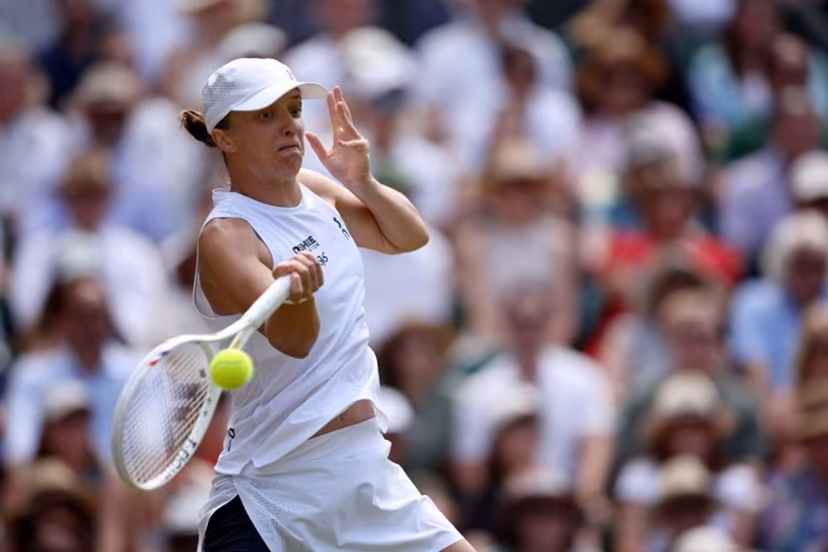 Poland's Iga Swiatek returns to Philippines' Alexandra Eala during their women's singles third round tennis match on the sixth day of the 2026 Wimbledon Championships at The All England Lawn Tennis and Croquet Club in Wimbledon, southwest London, on July 4, 2026. Henry Nicholls / AFP
