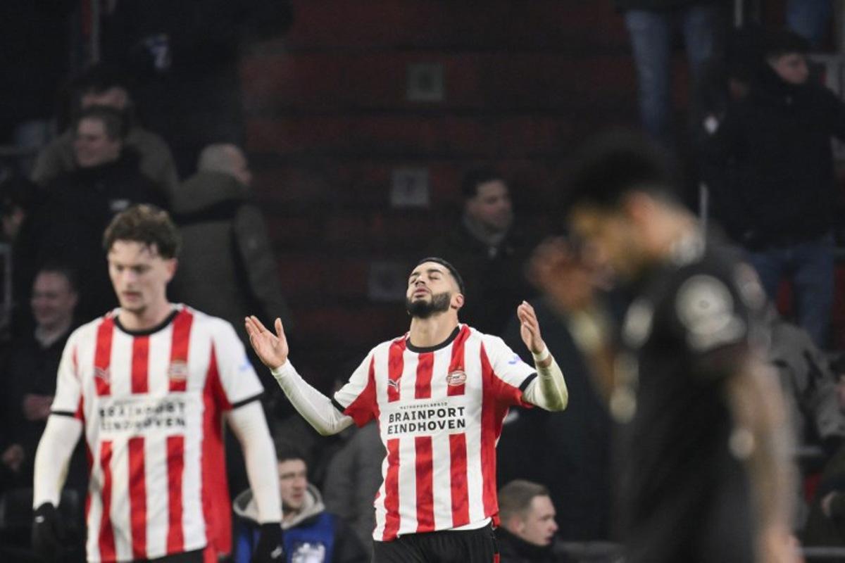 PSV Eindhoven's Moroccan midfielder #34 Ismael Saibari (C) celebrates after scoring his team's first goal during the UEFA Champions League league phase day 8 football match between PSV Eindhoven and Bayern Munich at Philips Stadion in Eindhoven on January 28, 2026. JOHN THYS / AFP