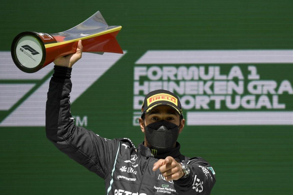 Mercedes' British driver Lewis Hamilton celebrates on the podium after winning the Portuguese Formula One Grand Prix race at the Algarve International Circuit in Portimao on May 2, 2021. GABRIEL BOUYS / POOL / AFP