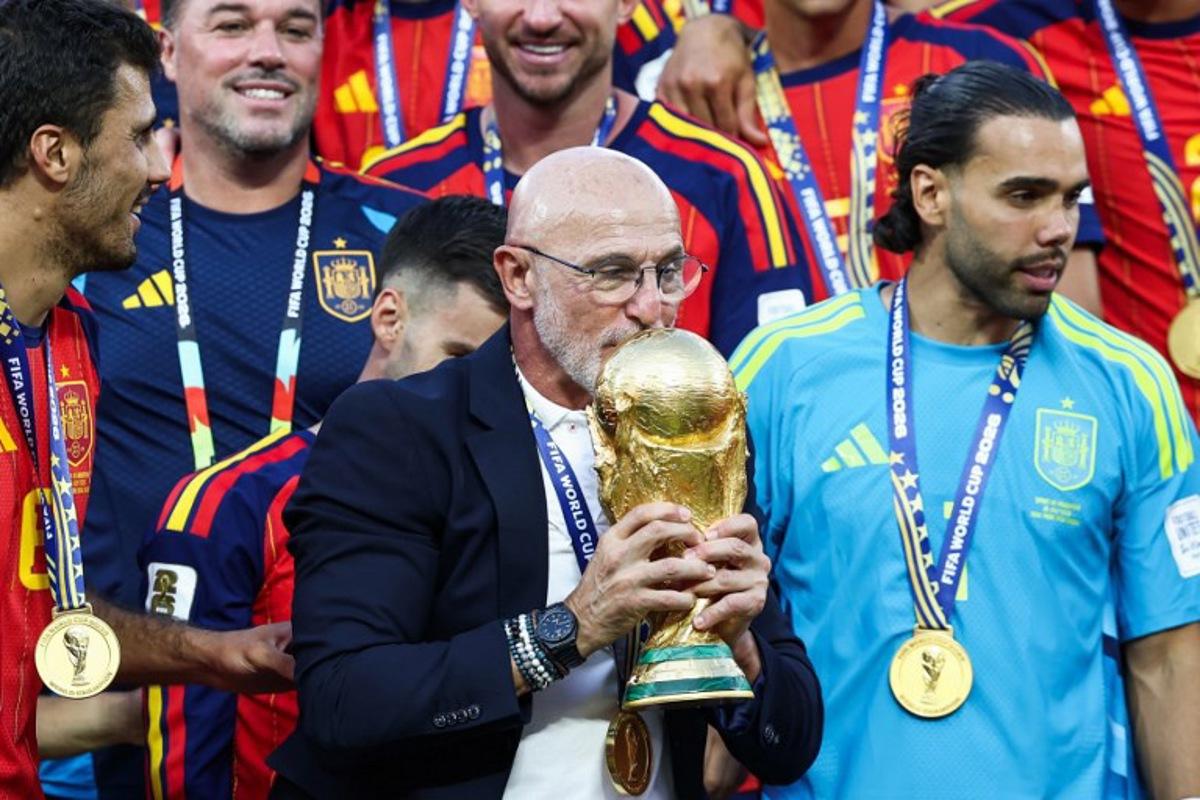 Spain's head coach Luis de la Fuente kisses the trophy after winning the 2026 World Cup football tournament final match between Spain and Argentina at the New York/New Jersey Stadium in East Rutherford on July 19, 2026. FRANCK FIFE / AFP