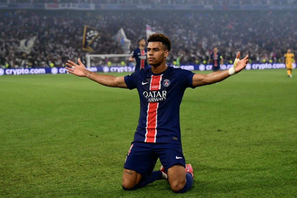 Paris Saint-Germain's French midfielder #14 Desire Doue celebrates after scoring during the UEFA Champions League final football match between Paris Saint-Germain (PSG) and Inter Milan in Munich, southern Germany on May 31, 2025. Marco BERTORELLO / AFP