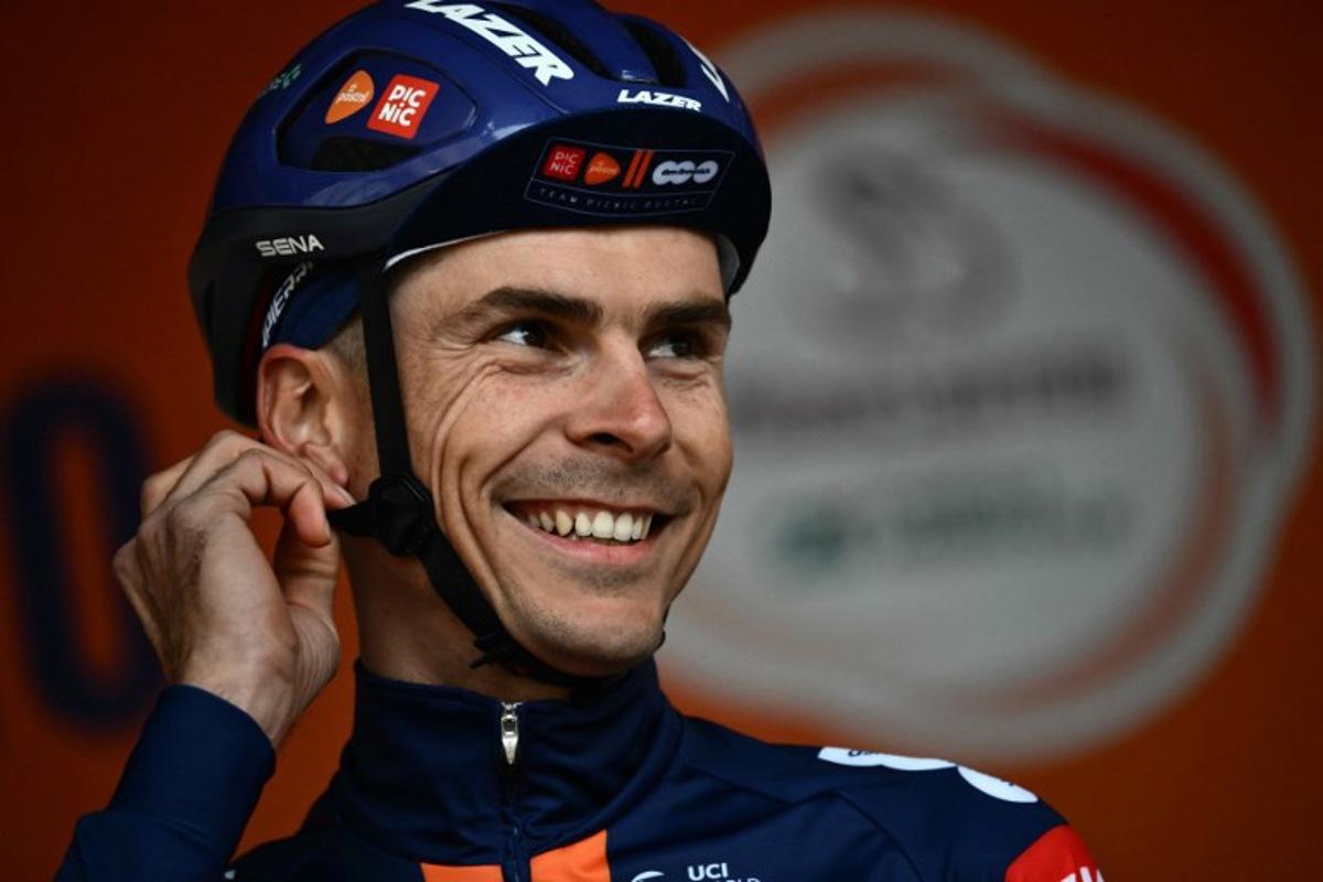 French rider of team PicNic Postnl, Warren Barguil, stands on stage before the start of the Milan - Sanremo one-day classic cycling race, in Pavia, near Milan, on March 22, 2025. Marco BERTORELLO / AFP