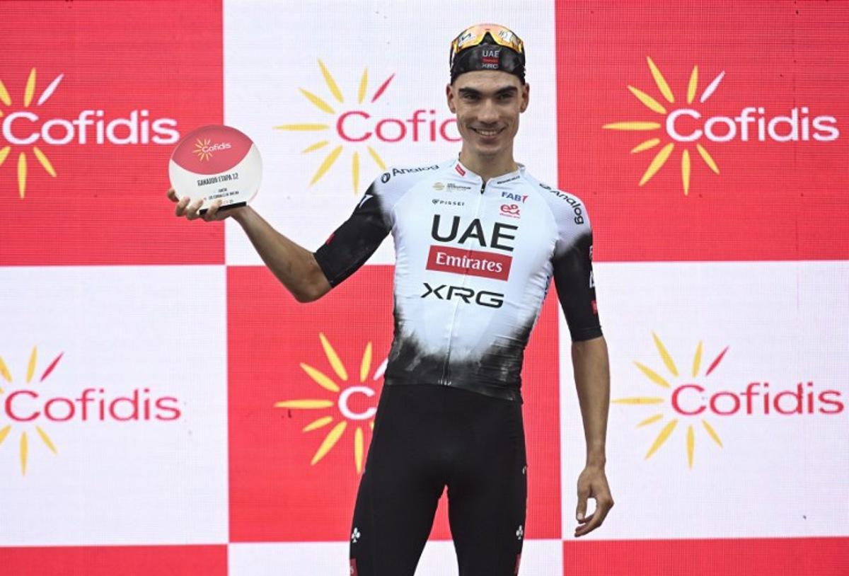 Team UAE's Spanish rider Juan Ayuso celebrates on the podium after winning the 12th stage of the Vuelta a Espana, a 144.9 km race between Laredo and Corrales de Buelna, on September 4, 2025. ANDER GILLENEA / AFP