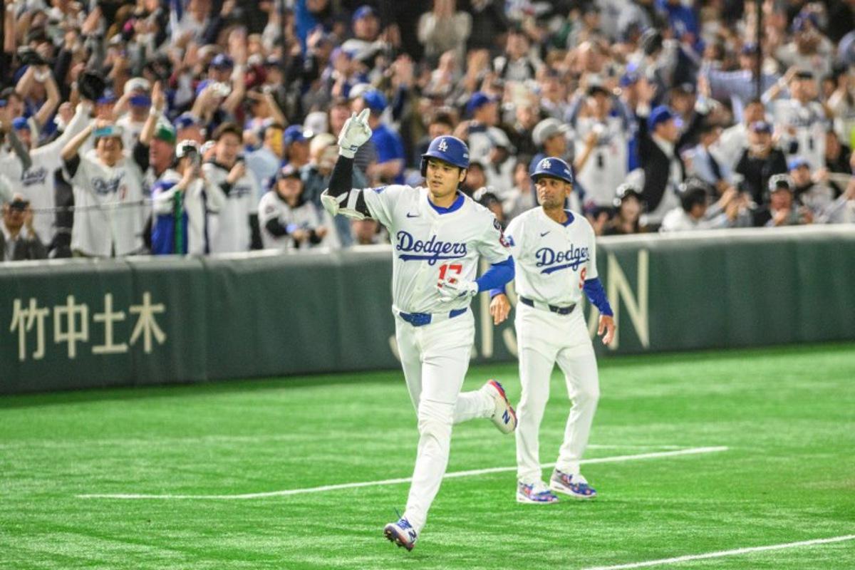Los Angeles Dodgers's Shohei Ohtani celebrates after hitting a home-run during the baseball game between the Los Angeles Dodgers and Chicago Cubs in the MLB Tokyo Series at the Tokyo Dome in Tokyo on March 19, 2025. Philip FONG / AFP