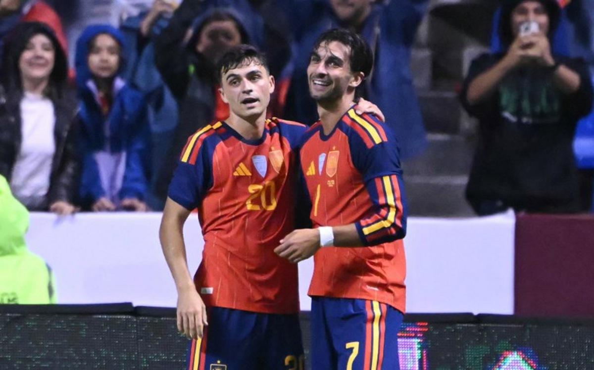 Spain's midfielder #20 Pedri celebrates with Spain's forward #07 Ferran Torres after scoring his team's second goal during the international friendly football match between Peru and Spain at Cuauhtemoc Stadium in Puebla, Mexico, on June 8, 2026. CARL DE SOUZA / AFP