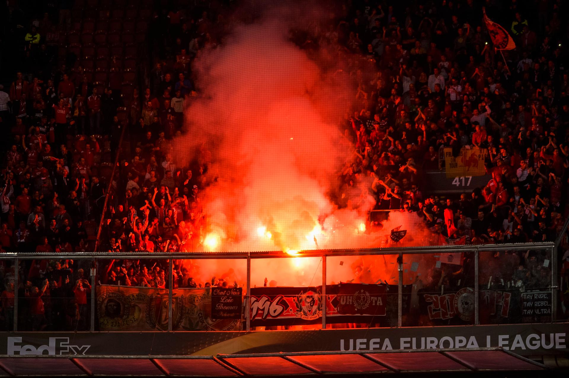 Standard's supporters pictured surrounded by smoke from fireworks during a game of the second day of the group stage of the Europa League competition between Dutch soccer team Ajax Amsterdam and Belgian club Standard de Liege, in Amsterdam, The Netherlands, Thursday 29 September 2016. BELGA PHOTO NICOLAS LAMBERT