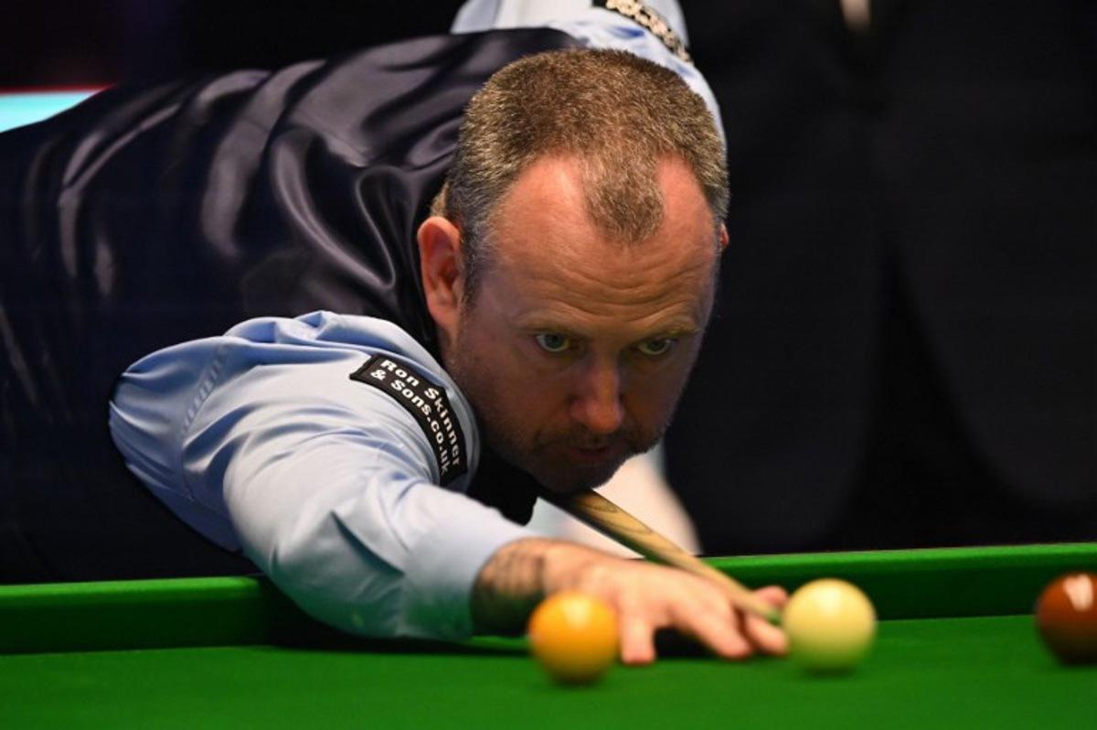 Wales' Mark Williams plays a shot during the Masters snooker tournament final against England's Judd Trump at Alexandra Palace in London on January 15, 2023. JUSTIN TALLIS / AFP