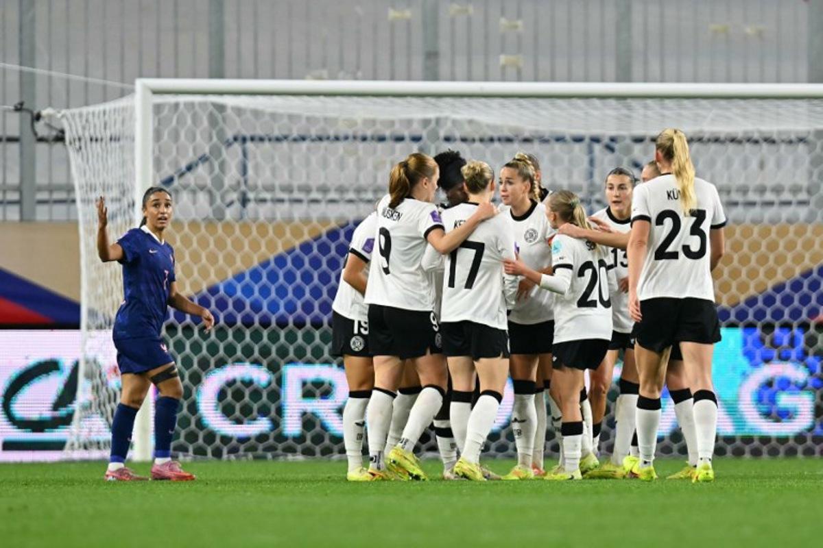 Germany's players celebrate after scoring Germany's first goal during the UEFA Women's Nations League semi-final football match between France and Germany at the Michel-d'Ornano Stadium in Caen, northwestern France, on October 28, 2025. LOU BENOIST / AFP