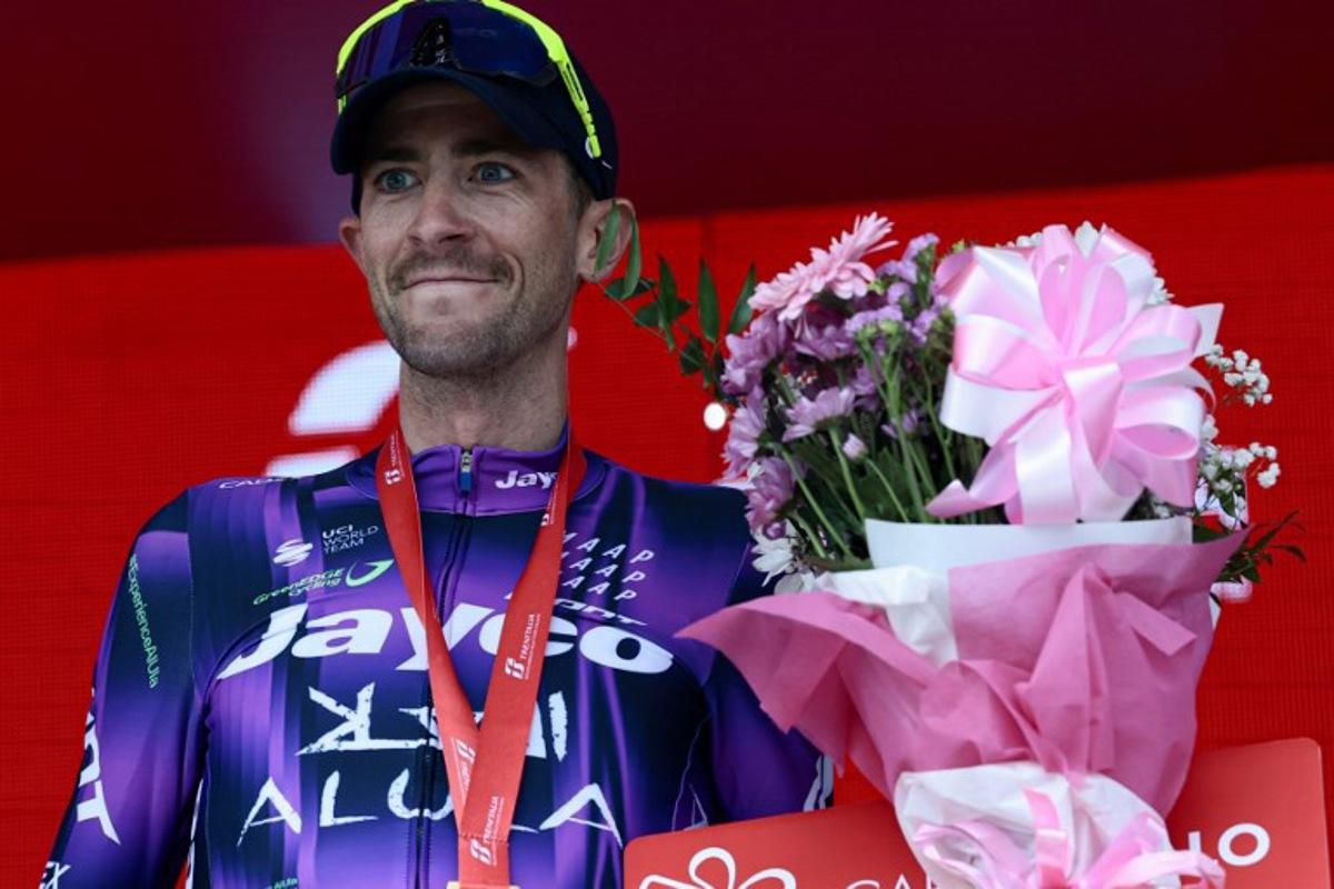 Team Jayco AlUla's Australian rider Chris Harper celebrates on the podium after winning the 20th stage of the 108th Giro d'Italia cycling race 205kms from Verres to Sestriere on May 31, 2025. Luca Bettini / AFP