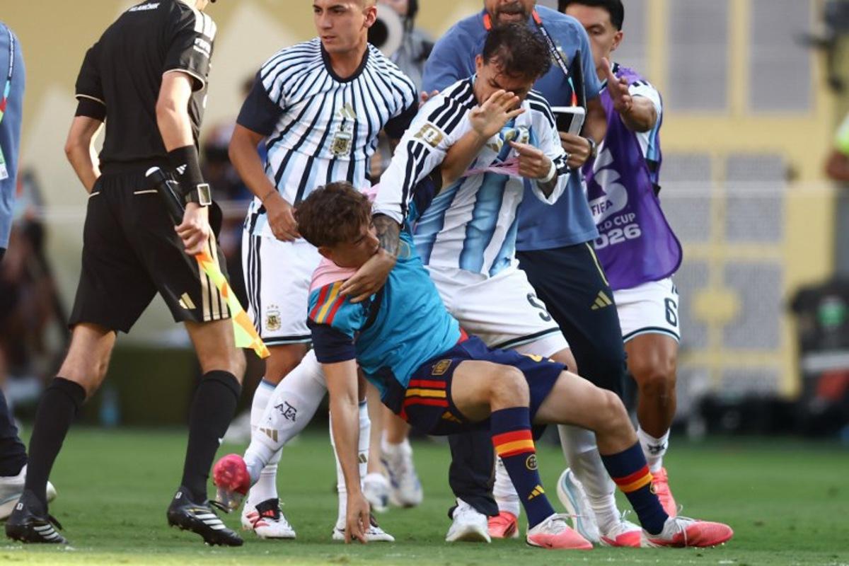 (FILES) Argentina's midfielder #05 Leandro Paredes (top) clashes with Spain's midfielder #09 Gavi during the 2026 World Cup football tournament final match between Spain and Argentina at the New York/New Jersey Stadium in East Rutherford on July 19, 2026. FIFA announced on July 29, 2026 that it had opened proceedings into some Argentina players for their behaviour after losing the World Cup to Spain. A handful of Argentina players and staff confronted their Spanish rivals after the final whistle of the final in New York which Spain won 1-0 after extra time. Argentina players including Nahuel Molina, Thiago Almada and Leandro Paredes, as well as Argentinian official Roberto Ayala, were involved in the incidents, as was Spain's Pablo Martin Paez Gavira. CHARLY TRIBALLEAU / AFP