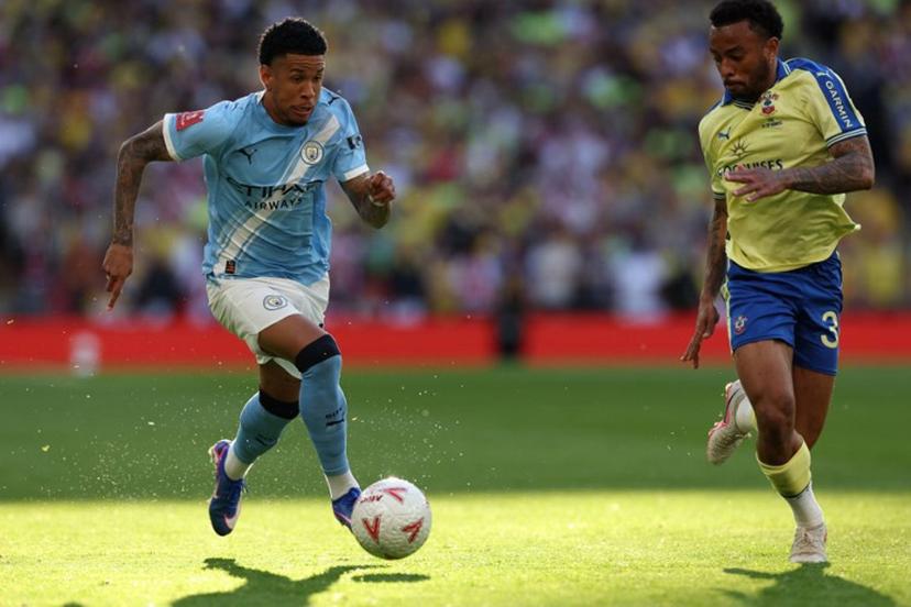 Manchester City's Brazilian midfielder #26 Savinho (L) runs at Southampton's Brazilian defender #34 Welington (R) during the English FA Cup semi final football match between Manchester City and Southampton at Wembley stadium in London, on April 25, 2026. Adrian Dennis / AFP