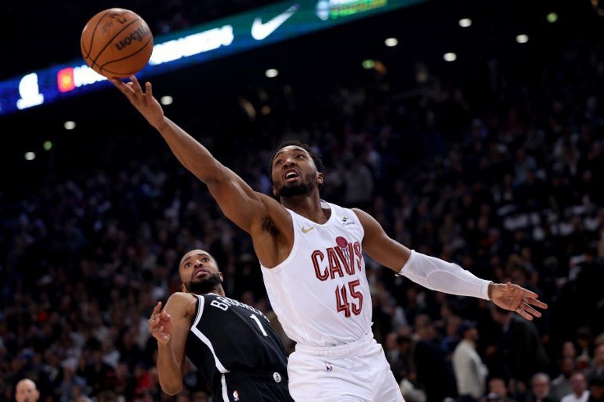 Cleveland Cavaliers' US Point Guard Donovan Mitchell (R) jumps to score in front of Brooklyn Nets' US Point Guard Mikal Bridges (L) during the NBA regular season basketball match between the Cleveland Cavaliers and the Brooklyn Nets at the Accor Arena in Paris on January 11, 2024. Emmanuel Dunand / AFP