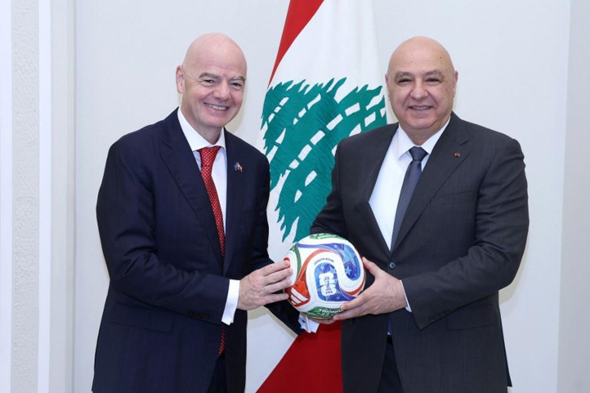 A handout photograph released by the Lebanese Presidency's press office shows FIFA president Gianni Infantino posing with Lebanese President Joseph Aoun (R) after their meeting at the presidential palace of Baabda, east of Beirut, on November 25, 2025. HANDOUT / Lebanese Presidency / AFP