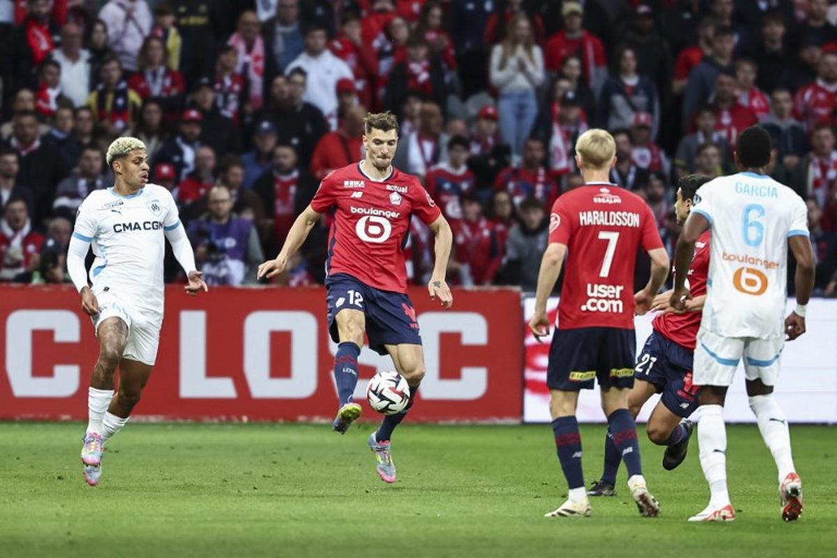 Lille's Belgian defender #12 Thomas Meunier (2nd L) controls the ball next to Marseille's Brazilian forward #44 Luis Henrique (L) during the French L1 football match between Lille (LOSC) and Olympique de Marseille (OM) at the Pierre-Mauroy stadium in Villeneuve-d'Ascq, northern France, on May 4, 2025. Sameer Al-DOUMY / AFP
