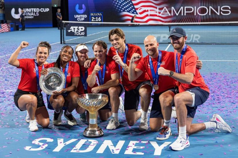 Players of Team USA celebrate with the trophy after beating team Poland in the finals of the United Cup tennis tournament on Ken Rosewall Arena in Sydney on January 5, 2025. Steve CHRISTO / AFP