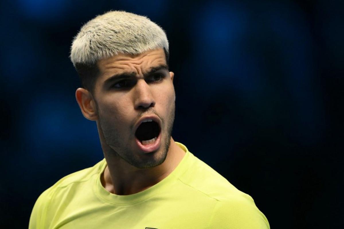 Spain's Carlos Alcaraz celebrates after winning his match against Australia's Alex De Minaur at the ATP Finals tennis tournament in Turin on November 9, 2025. Marco BERTORELLO / AFP