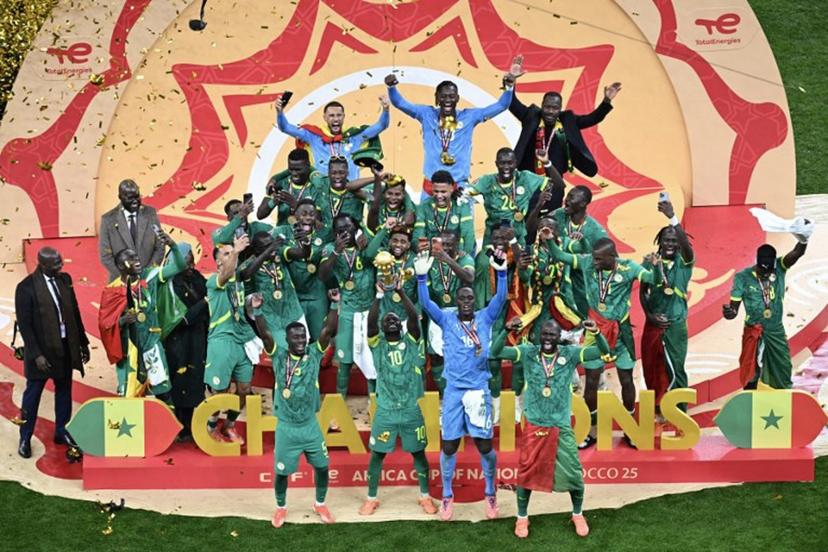 Senegal players celebrate with the trophy after winning the Africa Cup of Nations (CAN) final football match against Morocco at the Prince Moulay Abdellah Stadium in Rabat on January 18, 2026. Paul ELLIS / AFP