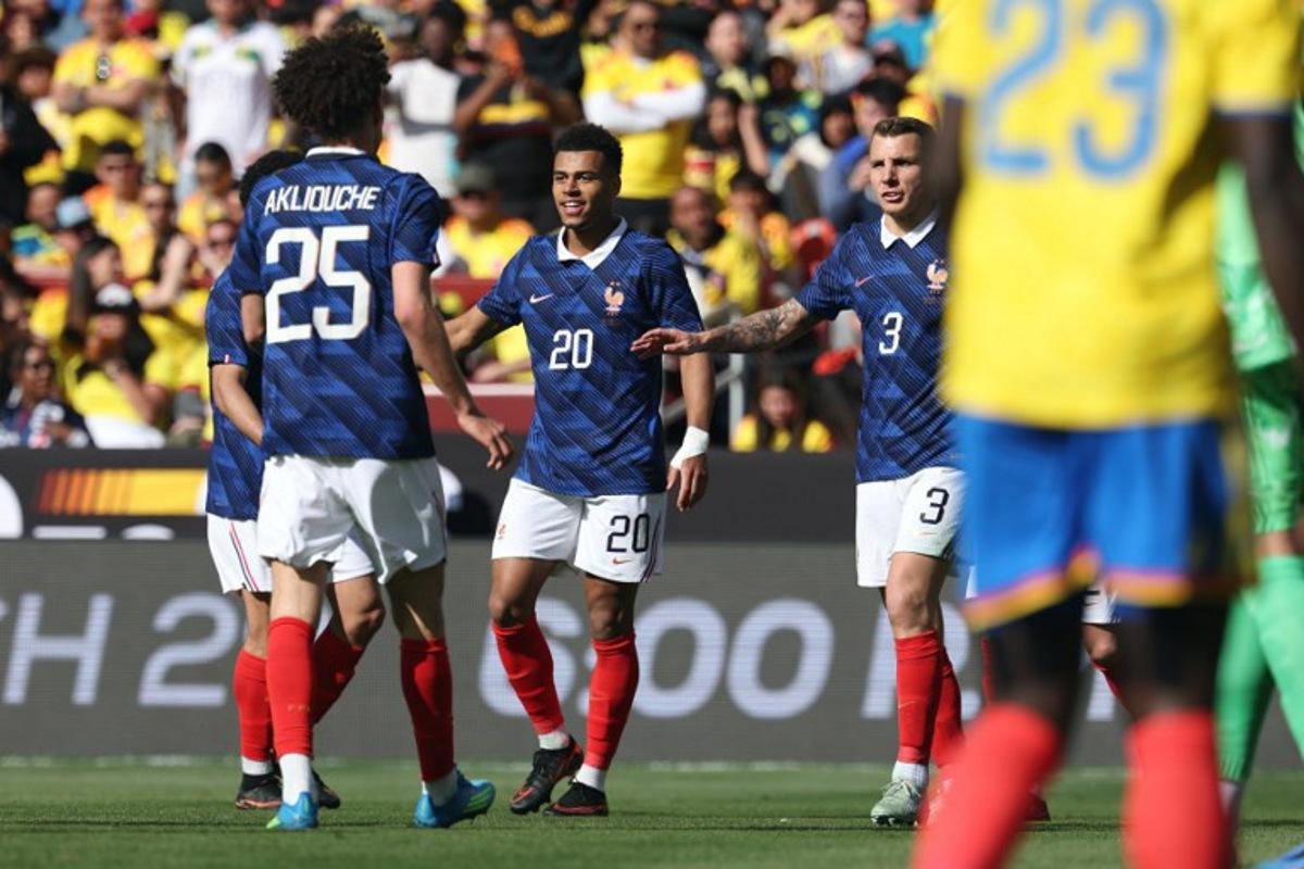 France's forward #20 Desire Doue is congratulated by teammates after scoring his second goal during a friendly football match between Colombia and France at Northwest Stadium in Landover, Maryland, on March 29, 2026. FRANCK FIFE / AFP