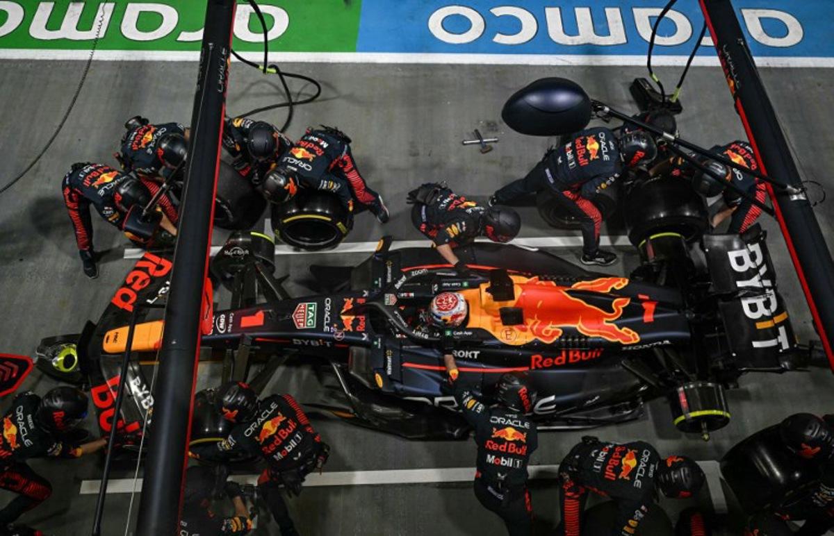 Mechanics work on the car of Red Bull Racing's Dutch driver Max Verstappen in the pit lane during the Singapore Formula One Grand Prix night race at the Marina Bay Street Circuit in Singapore on September 17, 2023. MOHD RASFAN / AFP
