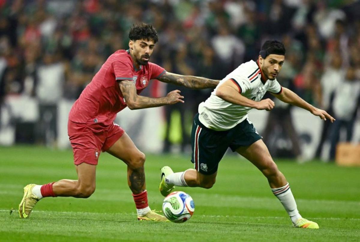 Portugal's defender #05 Samu Costa (L) and Mexico's forward #09 Raul Alonso Jimenez (R) fight for the ball during a friendly football match between Mexico and Portugal at the Banorte (formerly known as Azteca) Stadium in Mexico City on March 28, 2026. CARL DE SOUZA / AFP