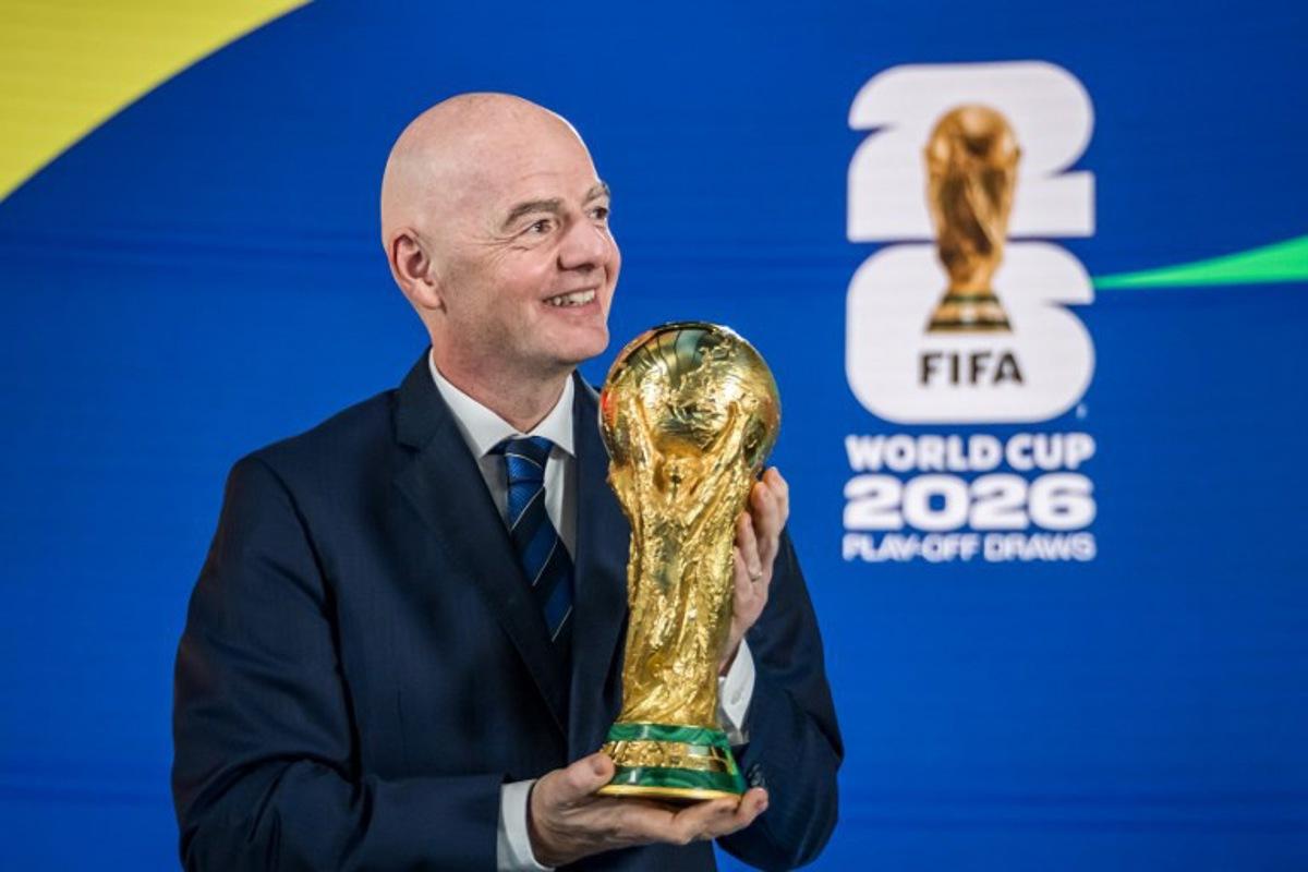 FIFA President Gianni Infantino poses with the 2026 FIFA World Cup trophy following the 2026 FIFA World Cup European Play-Off draw at the FIFA's Home of Football in Zurich on November 20, 2025. Fabrice COFFRINI / AFP