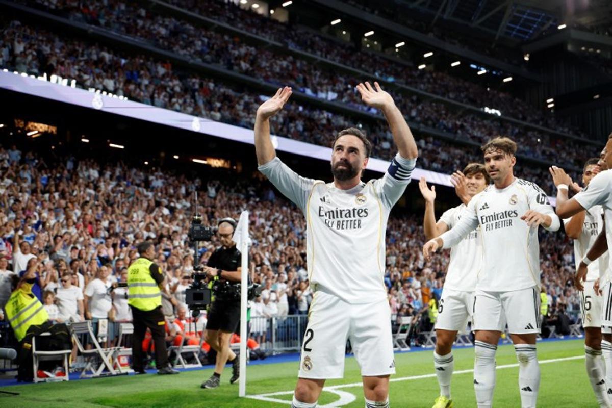 Real Madrid's Spanish defender #02 Dani Carvajal celebrates Real Madrid's Spanish forward #16 Gonzalo Garcia's goal during the Spanish league football match between Real Madrid CF and Athletic Club Bilbao at Santiago Bernabeu Stadium in Madrid on May 23, 2026. Pierre-Philippe MARCOU / AFP