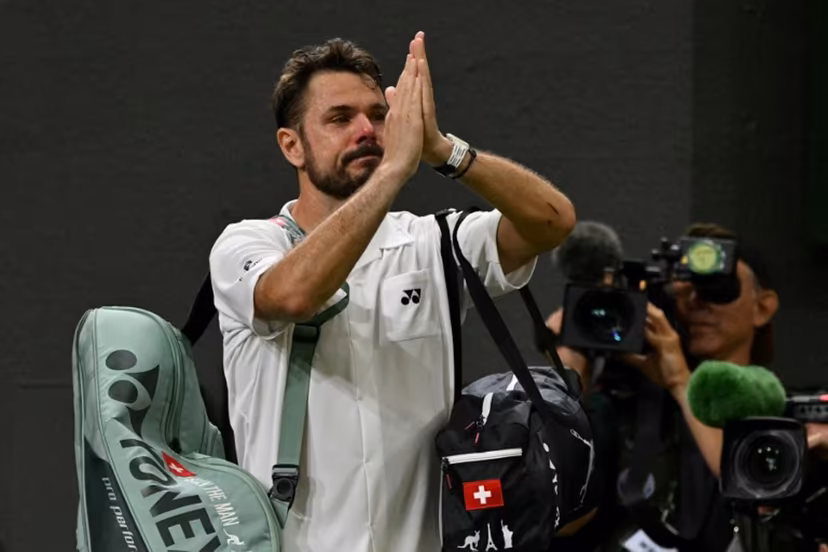 Switzerland's Stan Wawrinka gestures to the crowd as he leaves following his defeat to Italy's Matteo Berrettini during their men's singles first round tennis match on the second day of the 2026 Wimbledon Championships at The All England Lawn Tennis and Croquet Club in Wimbledon, southwest London, on June 30, 2026. Glyn KIRK / AFP