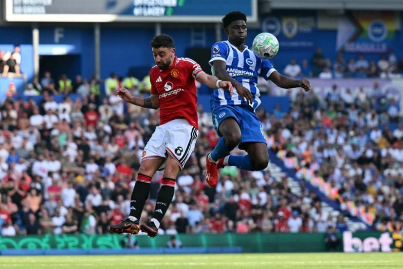 Manchester United's Portuguese midfielder #08 Bruno Fernandes (L) vies with Brighton's Cameroonian midfielder #17 Carlos Baleba during the English Premier League football match between Brighton and Hove Albion and Manchester United at the American Express Community Stadium in Brighton, southern England on May 24, 2026. Glyn KIRK / AFP