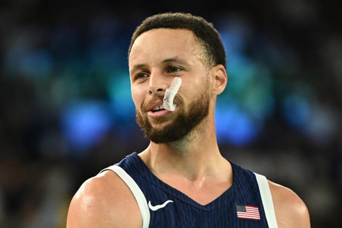 USA's #04 Stephen Curry looks on, with his dental protection displaced, in the men's quarterfinal basketball match between Brazil and the USA during the Paris 2024 Olympic Games at the Bercy Arena in Paris on August 6, 2024. Aris MESSINIS / AFP