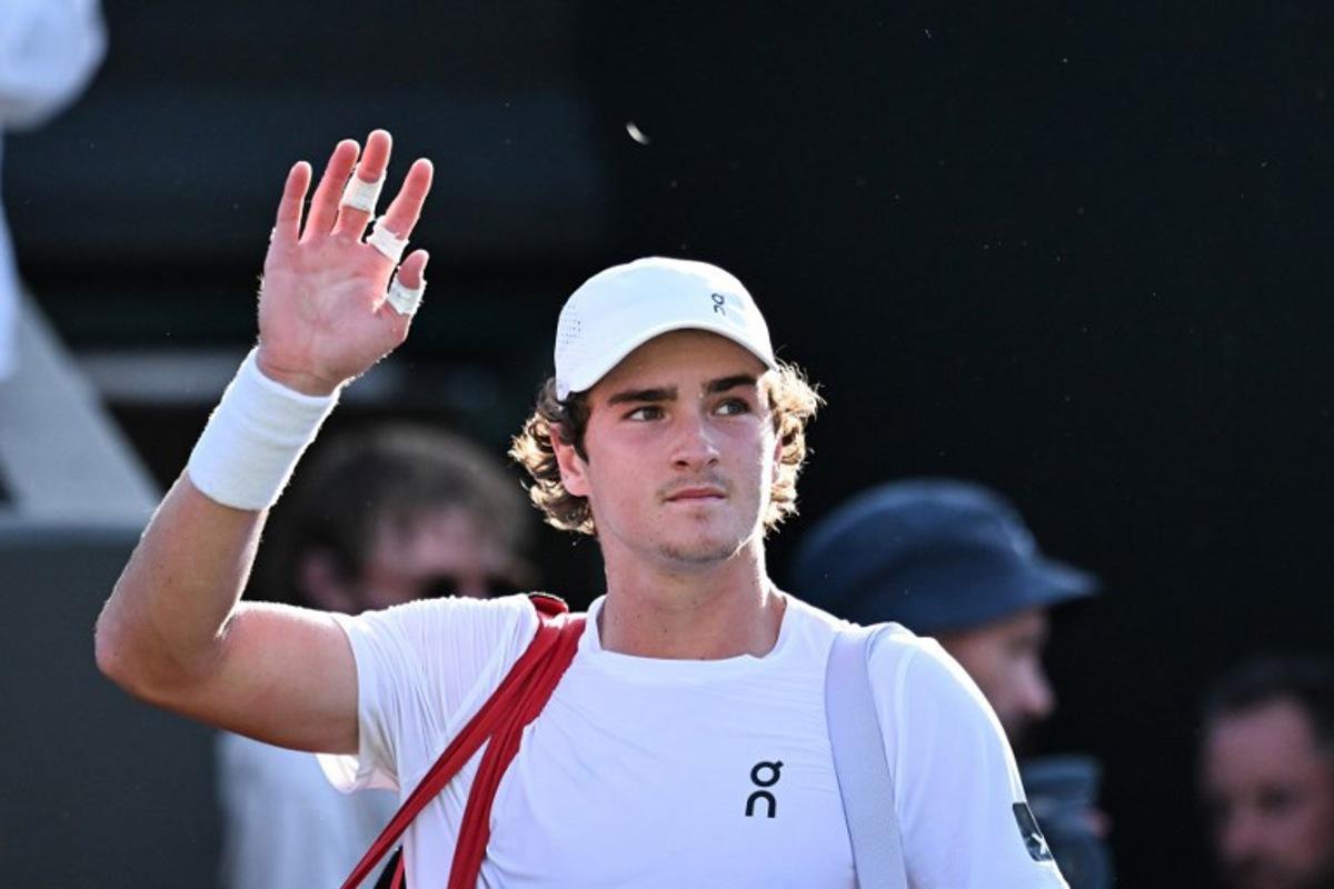 Brazil's Joao Fonseca acknowledges the audience as he leaves the court following his defeat against Chile's Nicolas Jarry during their men's singles third round tennis match on the fifth day of the 2025 Wimbledon Championships at The All England Lawn Tennis and Croquet Club in Wimbledon, southwest London, on July 4, 2025. Kirill KUDRYAVTSEV / AFP