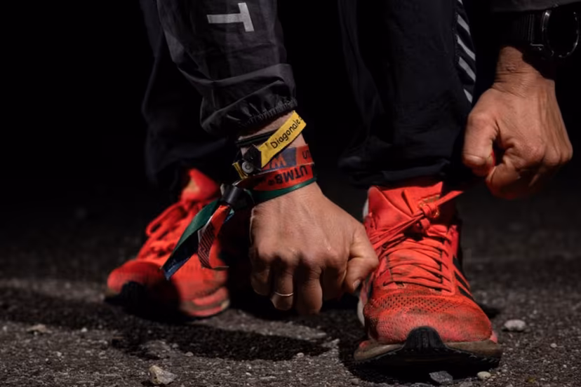 French runner Claire Bannwarth puts on her shoes during a training session in Saint-Louis, eastern France, on April 18, 2024. "My connected watch often tells me to take a break". An atypical ultra-trail phenomenon, France's Claire Bannwarth spends most of her time running, very slowly, and her vacations winning the world's toughest races. SEBASTIEN BOZON / AFP
