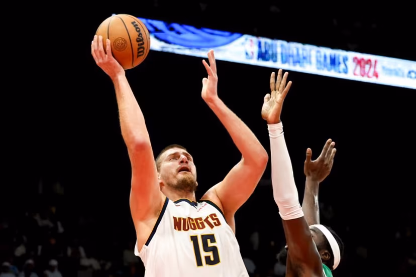 Denver Nuggets' center #15 Nikola Jokic jumps to shoot during the NBA Preseason game between the Boston Celtics and the Denver Nuggets at the Etihad Arena in Abu Dhabi on October 6, 2024. Fadel Senna / AFP
